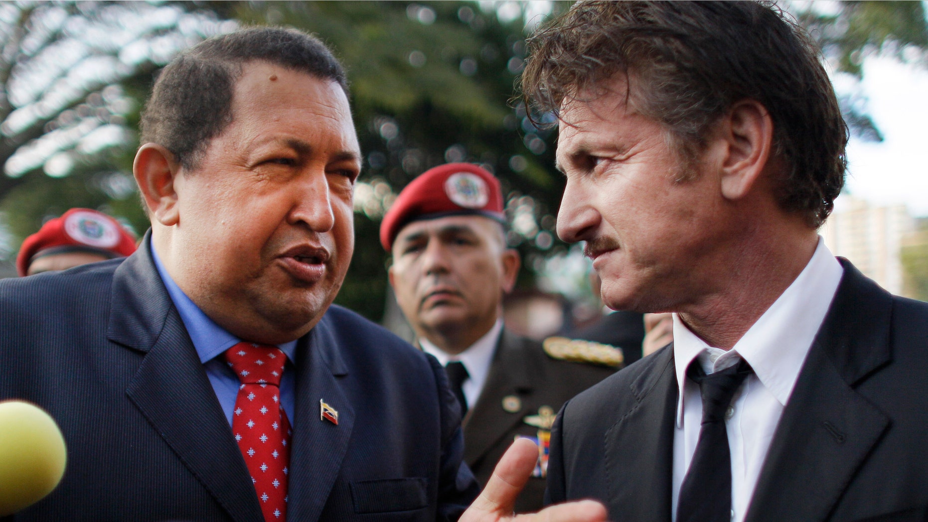 Venezuela's President Hugo Chavez, left, talks to actor Sean Penn, of United States, who visited the presidential palace in Caracas, Venezuela, Thursday, Feb. 16, 2012. (AP Photo/Ariana Cubillos)