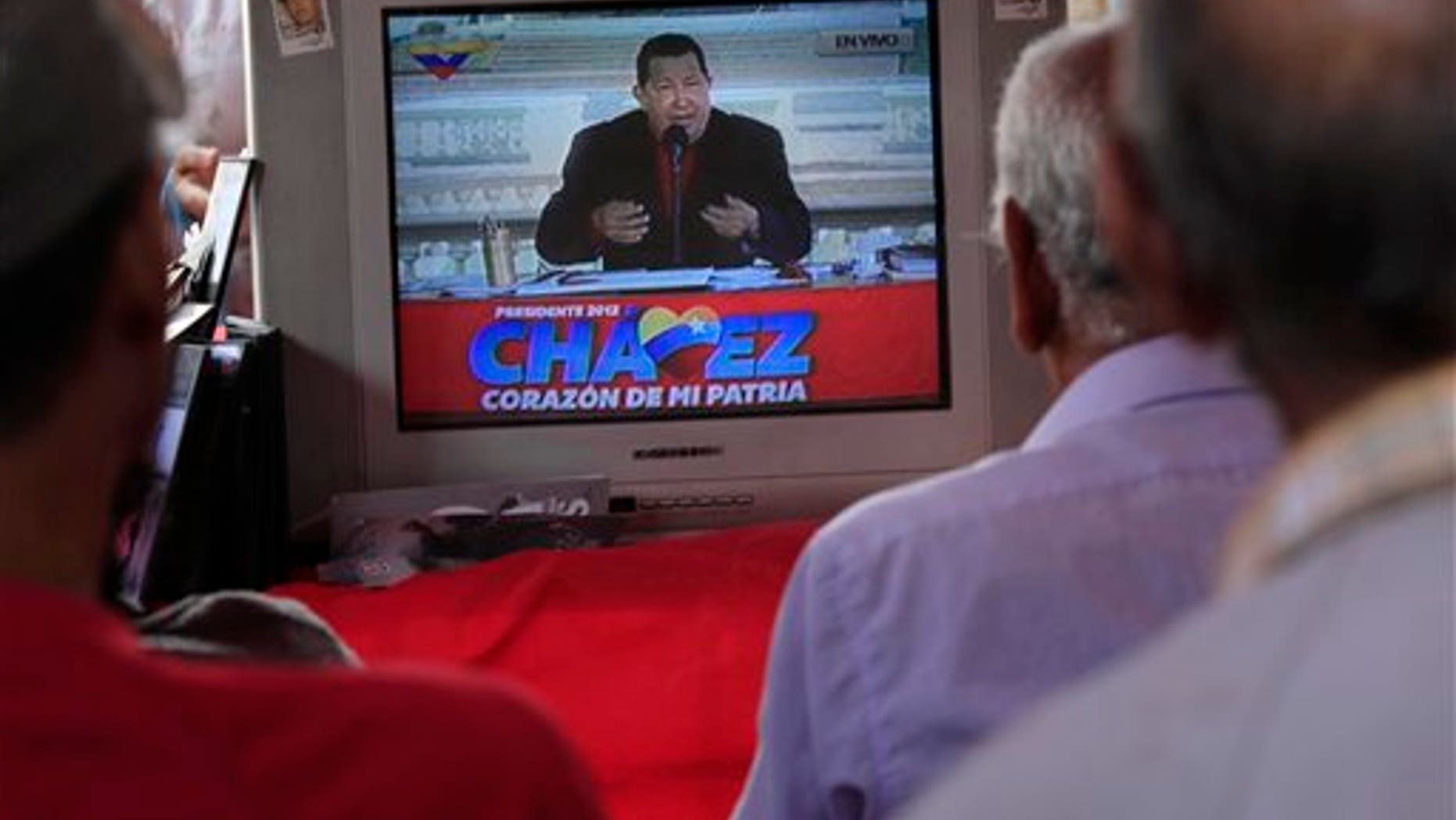 ADVANCE FOR USE SUNDAY, SEPT. 23, 2012 AND THEREAFTER - In this Sept. 5, 2012 photo, people watch a TV in Caracas, Venezuela broadcasting President Hugo Chavez delivering a speech as presidential candidate. Nearly 14 years after President Hugo Chavez took office, and despite the biggest oil bonanza in Venezuelas history, theres little outward sign of the nearly one trillion petrodollars that have flowed into the country. The populist president has used the oil wealth to buttress his support through cash handouts, state-run grocery stores and a gamut of other social programs. With more money in the economy, incomes are higher and the number of people living in poverty has fallen. Yet some experts say Chavez could have done much more to improve the countrys infrastructure, boost its economy and invest in the very oil industry that keeps Venezuela afloat. (AP Photo/Ariana Cubillos)