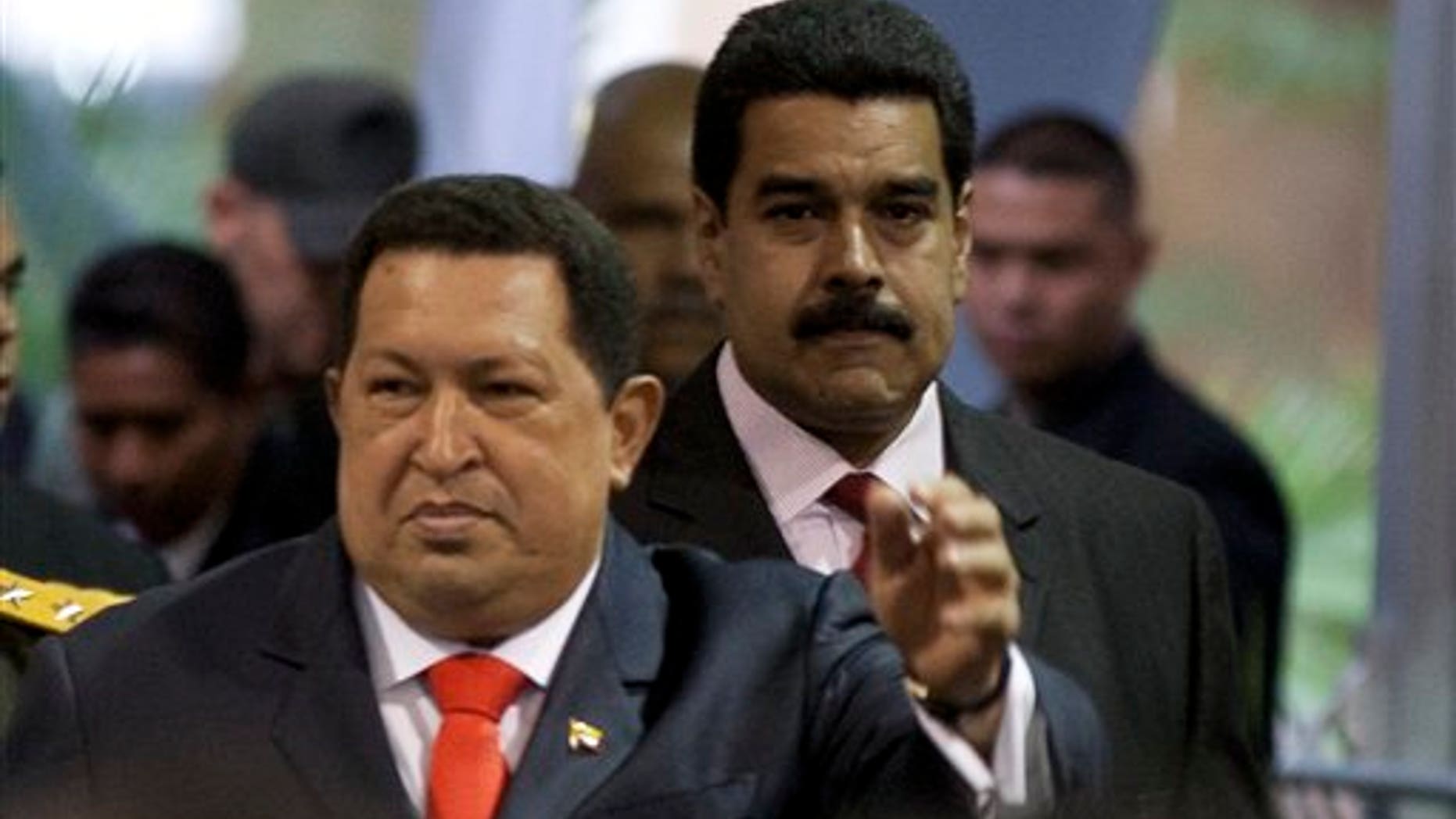 Nicolas Maduro, right, follows Venezuela's President Hugo Chavez as they arrive to the presidential ceremony.