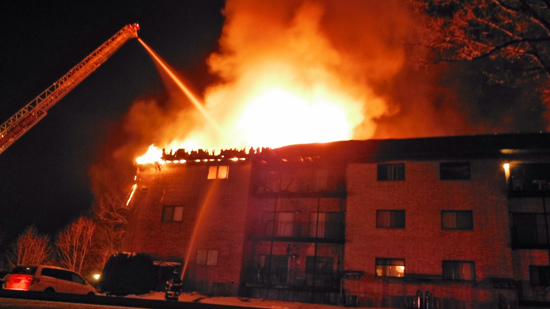 Jan. 5, 2013: Firefighters form Lowell's Ladder #3 fight a condominium fire in Chelmsford, Mass. The state fire marshal says two people died and four others were injured in the fire in northeastern Massachusetts.