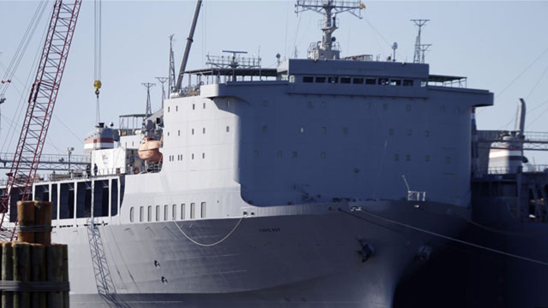 December 19, 2013: Workers unload equipment from the MV Cape Ray, part of the U.S. maritime reserve fleet in Portsmouth, Va. The U.S. ship will serve as the linchpin for the destruction of Syria’s most toxic chemical weapons (AP Photo)