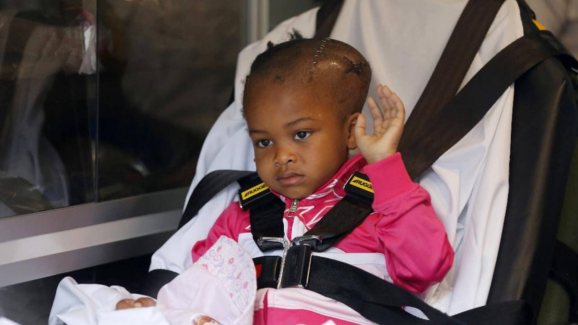 Four-year-old Jacele Johnson, who was shot in the head on May 22 outside a prom party in Chicago's Englewood neighborhood, waves to the media as she is released from Comer Childrens Hospital on Monday, June 1, 2015, in Chicago. Johnson was put in an ambulance that would take her to a Minnesota hospital where she will undergo further treatment. (Jose M. Osorio/Chicago Tribune via AP) MANDATORY CREDIT CHICAGO TRIBUNE; CHICAGO SUN-TIMES OUT; DAILY HERALD OUT; NORTHWEST HERALD OUT; THE HERALD-NEWS OUT; DAILY CHRONICLE OUT; THE TIMES OF NORTHWEST INDIANA OUT; TV OUT; MAGS OUT; NO SALES