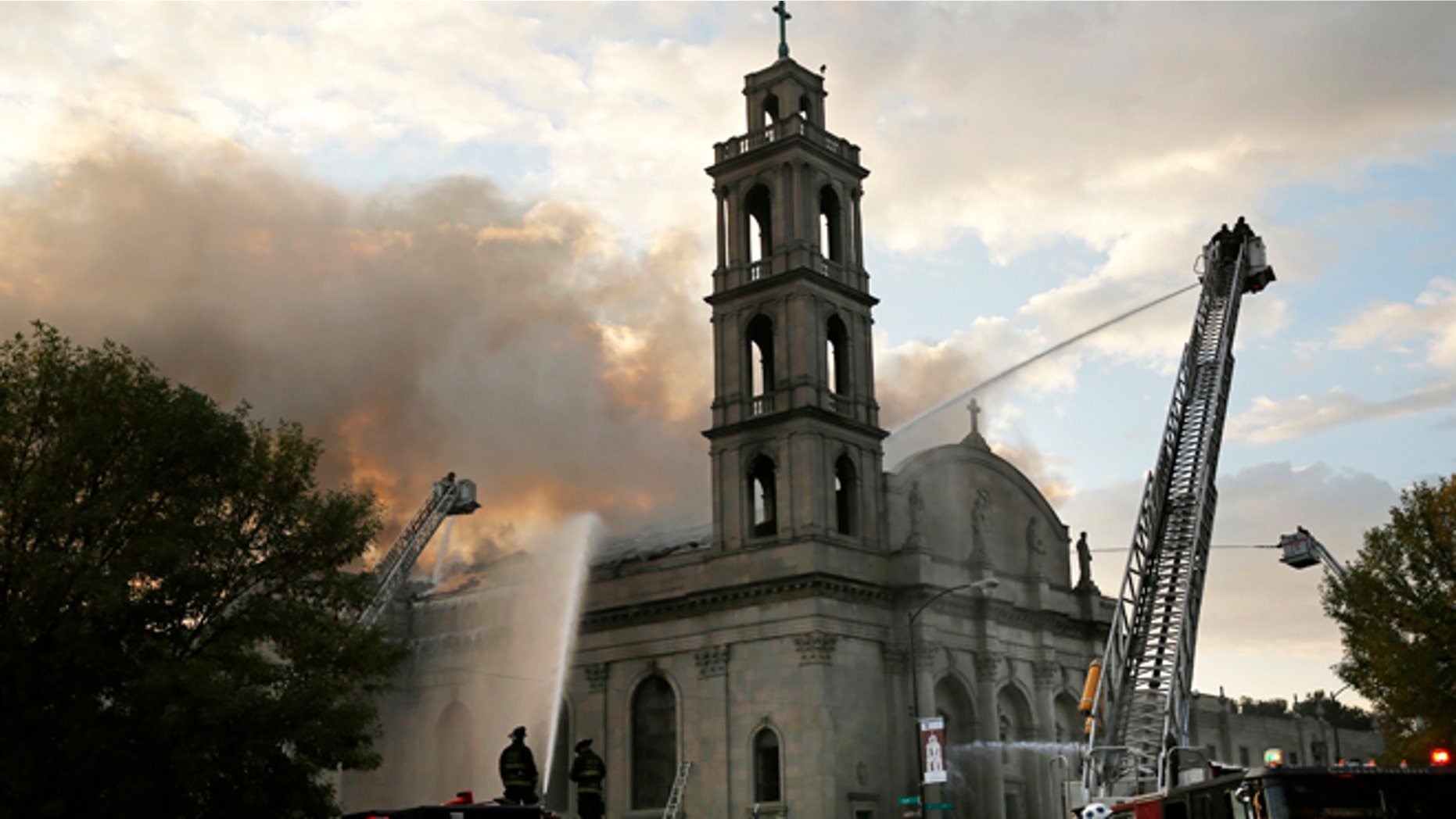 Chicago firefighters work at the scene of an extra-alarm fire at Shrine of Christ the King Church.