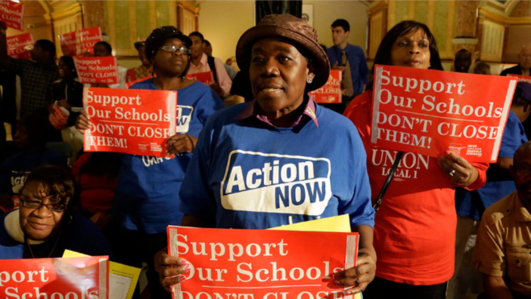 Protesters of Mayor Rahm Emmanuel's plan to close dozens of city schools rally in the rotunda at the Illinois State Capitol Wednesday, May 22, 2013 in Springfield Ill. The Chicago Board of Education was expected to take a final vote Wednesday on whether to close 53 schools. (AP Photo/Seth Perlman)