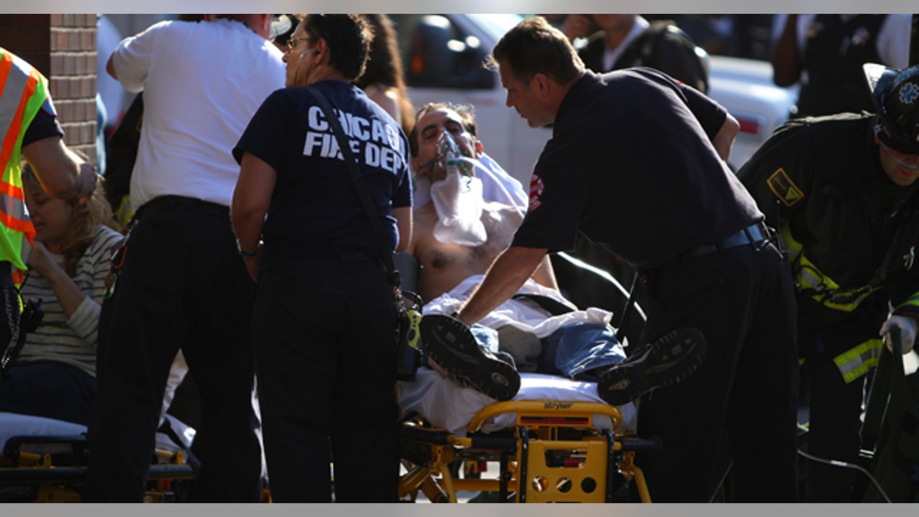 June 20: Emergency personnel tend to patients at the corner of Clark and Division after a fire in the Red Line in Chicago. (AP)