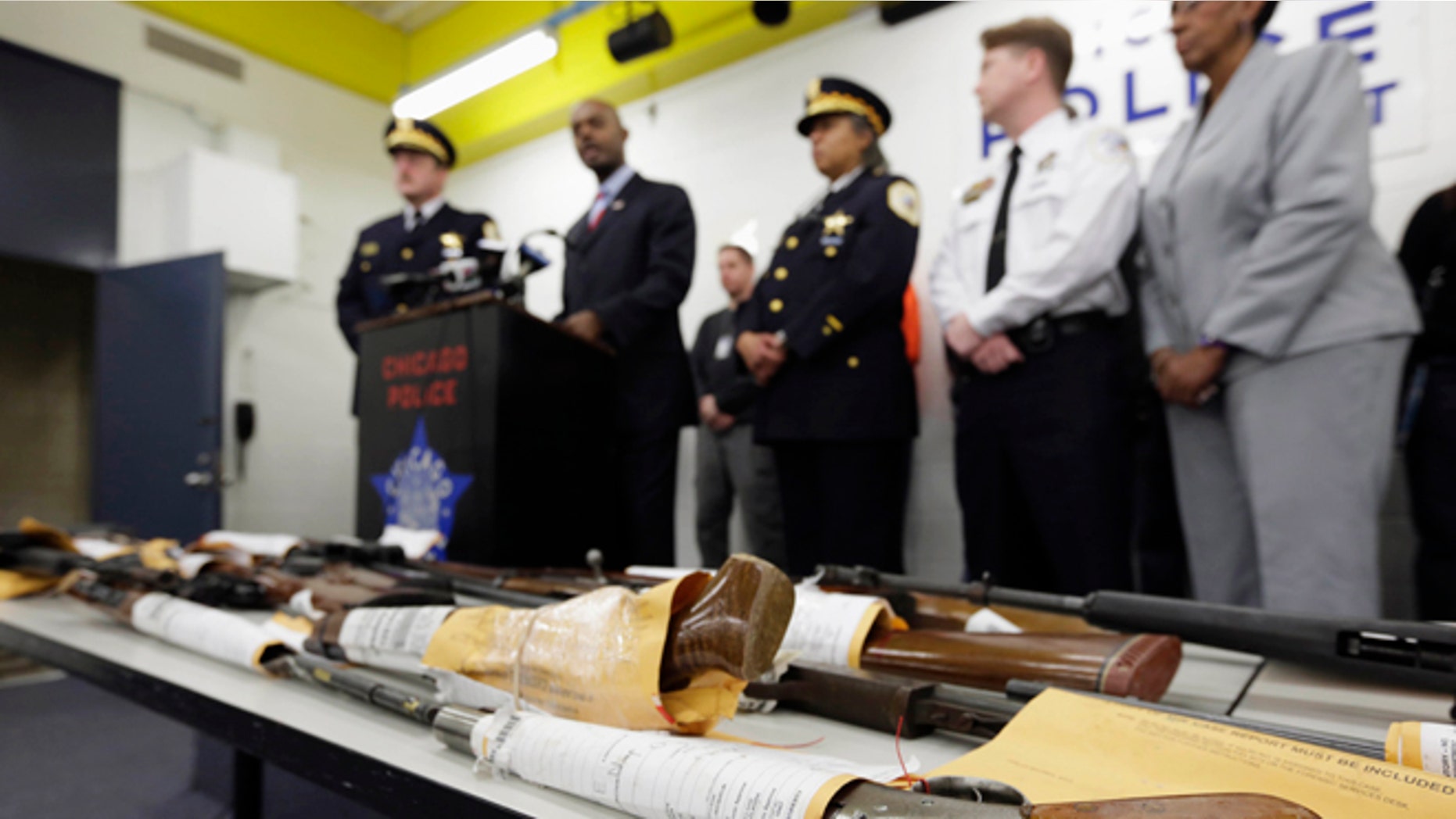 Jan. 28, 2013: In this file photo, Chicago Police First Deputy Superintendent Alfonsa Wysinger, second from left, speaks at a news conference in Chicago with a display of recently seized guns, part of the 574 that had been seized in the city since Jan. 1. The mounting homicide toll in President Barack Obamas hometown is giving ammunition to both sides in the nations debate about gun rights and safety. The city suffered through its deadliest January in more than a decade.