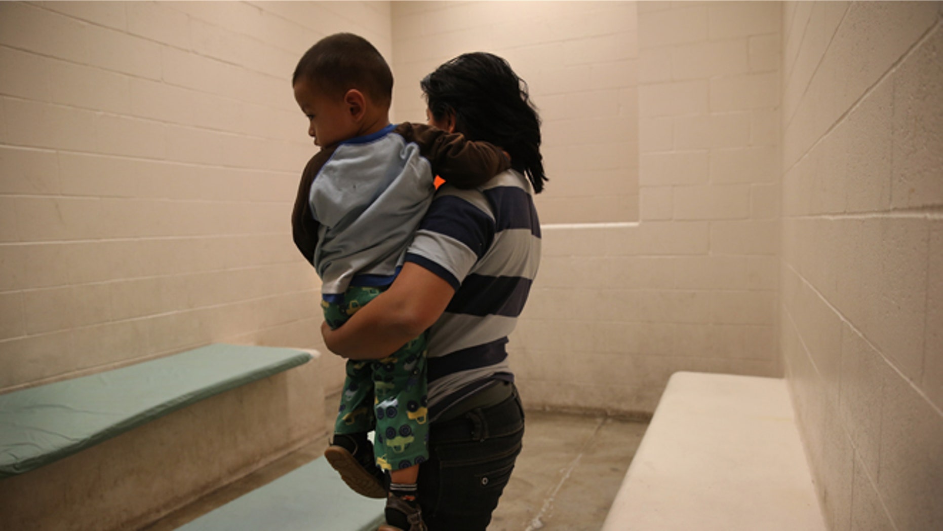 MCALLEN, TX - APRIL 11: A Honduran mother holds her toddler son at the U.S. Border Patrol detainee processing center on April 11, 2013 in McAllen, Texas. They had been caught by the Border Patrol while crossing illegally from Mexico into Texas. According to the Border Patrol, undocumented immigrant crossings have increased more than 50 percent in Texas' Rio Grande Valley sector in the last year. With more apprehensions, they have struggled to deal with overcrowding while undocumented immigrants are processed for deportation. (Photo by John Moore/Getty Images)