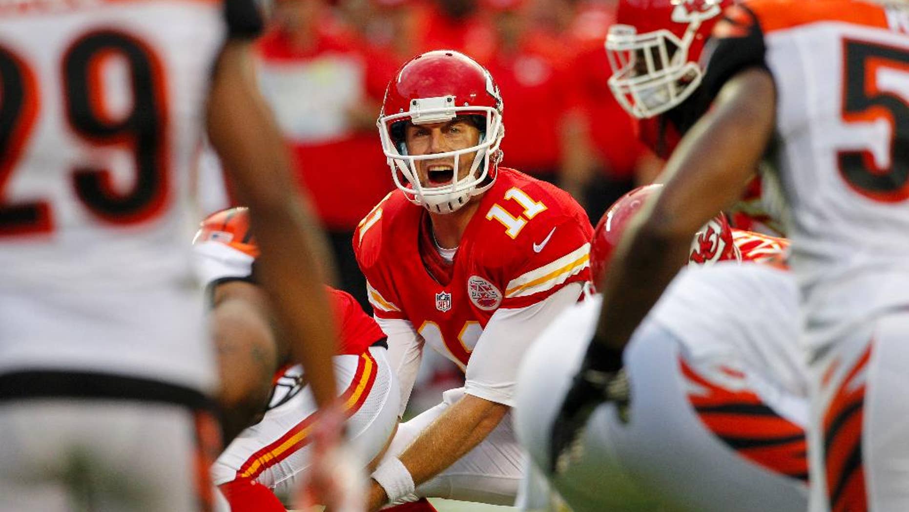 FILE - In this Aug. 7, 2014, file photo, Kansas City Chiefs quarterback Alex Smith (11) calls a play in the first half of an NFL preseason football game against the Cincinnati Bengals in Kansas City, Mo. Smith signed a $68 million extension Sunday, Aug. 31, 2014, to remain with the Chiefs through the 2018 season, a person familiar with the deal told The Associated Press. The person spoke on condition of anonymity because the team did not disclose the terms of the contract. (AP Photo/Colin E. Braley, File)
