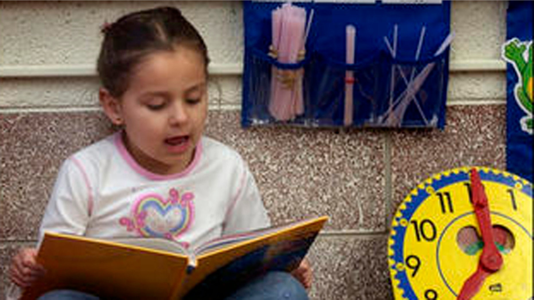 Kasandra Herrera, 6, reads a book in Spanish in Bianca Alvarez's dual language first grade classroom at Northwest Elementary School in Dodge City, Kan. Feb. 22, 2005. (AP Photo/Charlie Riedel)