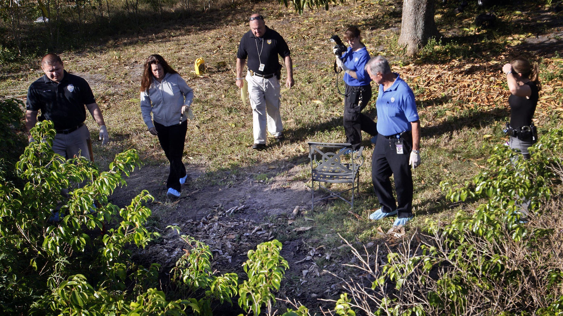 March 4: Delray Beach investigators gather in the backyard of the home of Clem Beauchamp in Delray Beach, Fla. Investigators were seen digging in a corner of Beauchamp's yard after he became a suspect in the death of his two children, found in a canal, and their mother, found in a landfill.