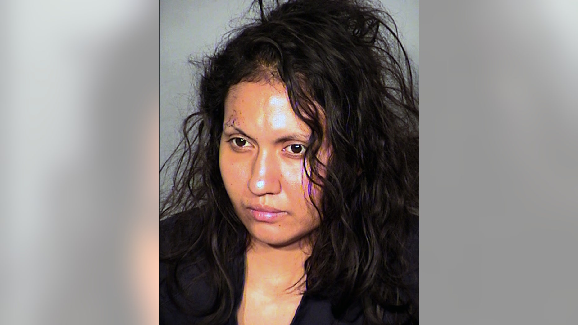 FILE - This undated booking photo provided by the Las Vegas Metropolitan Police Department shows Robledo Ibarra, 34, who faces felony charges after police say she tossed her two young children and herself out a second-story window on June 12, 2014. Ibarra was in a wheelchair Monday, June 30, 2014 for her initial court appearance in Las Vegas on two attempted counts of murder and two charges of child abuse causing substantial bodily harm. Her lawyer, Benson Lee, says he intends to file written documents seeking her release on bail from the Clark County jail. (AP Photo/Las Vegas Metropolitan Police Department,File)