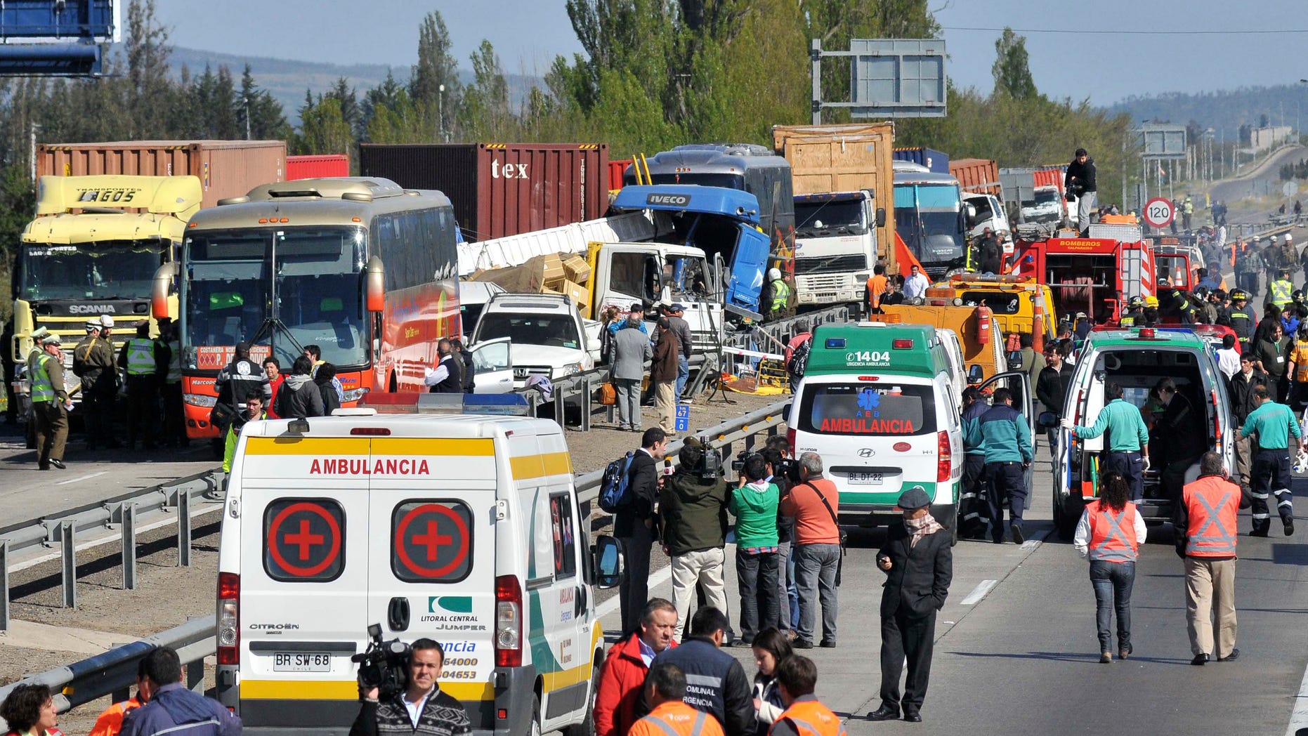 Emergency personnel gather at the scene of a multi-vehicle pile-up on a highway in Casablanca, about 43 miles or 70 kilometers from Santiago, Chile, Wednesday Oct. 12, 2011. According to government officials, at least four people died and 49 were injured.