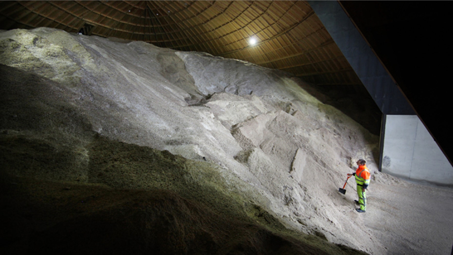 BISHOP'S STORTFORD, ENGLAND - NOVEMBER 08: Route engineer Richard Winter checks a pile of road salt at the Birchanger Depot on November 8, 2011 near Bishop's Stortford, England. The newly built salt dome at Birchanger Depot, located next to the M11 motorway, holds 5500 tonnes of road salt which is enough to fill 550 gritter lorry loads. The salt is used to prevent roads from icing over during winter months. The Highways Agency is asking all motorists to be prepared for poor conditions whilst driving this winter by carrying maps, an ice scraper, de-icer, torch with spare batteries, warm clothes and blankets. (Photo by Peter Macdiarmid/Getty Images)