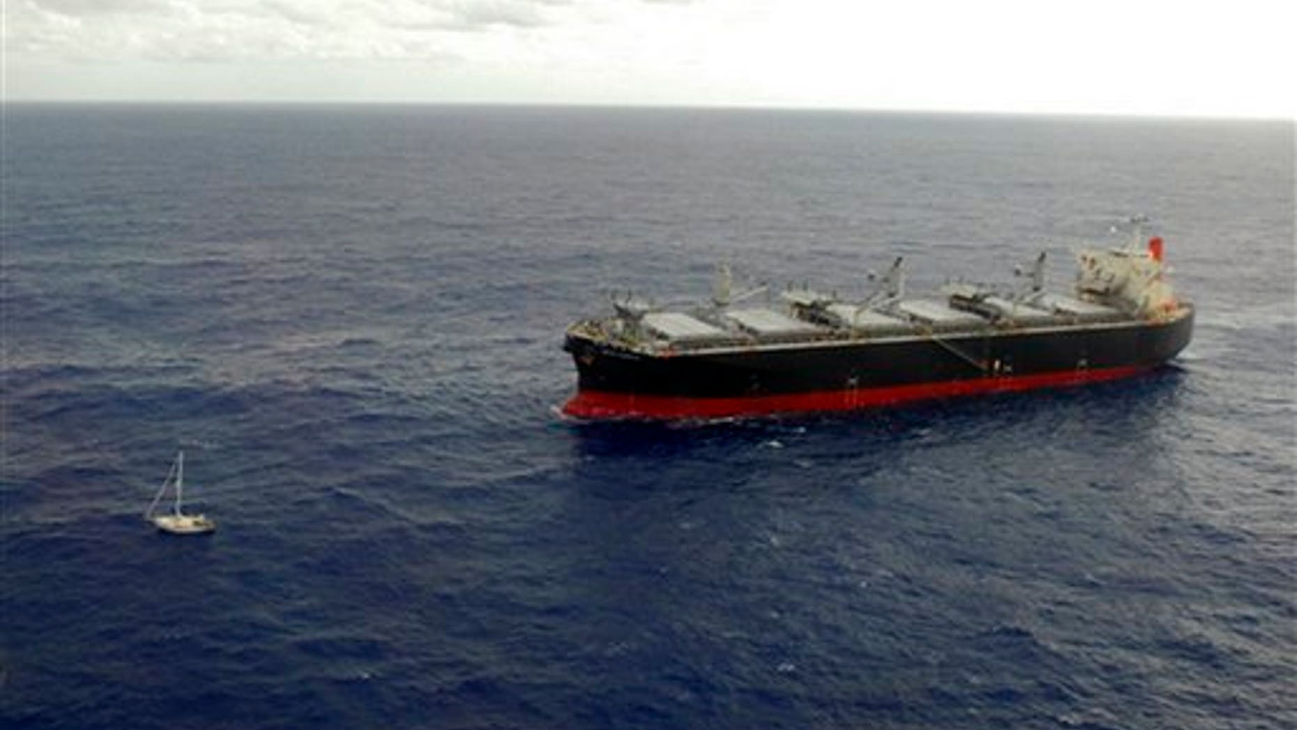 Jan. 4: Japan's merchant ship White Kingdom, right, approaches the 32-foot sailboat of U.S. sailor Thomas Louis Corogin to rescue him in the Pacific Ocean south of Easter Island, Chile.