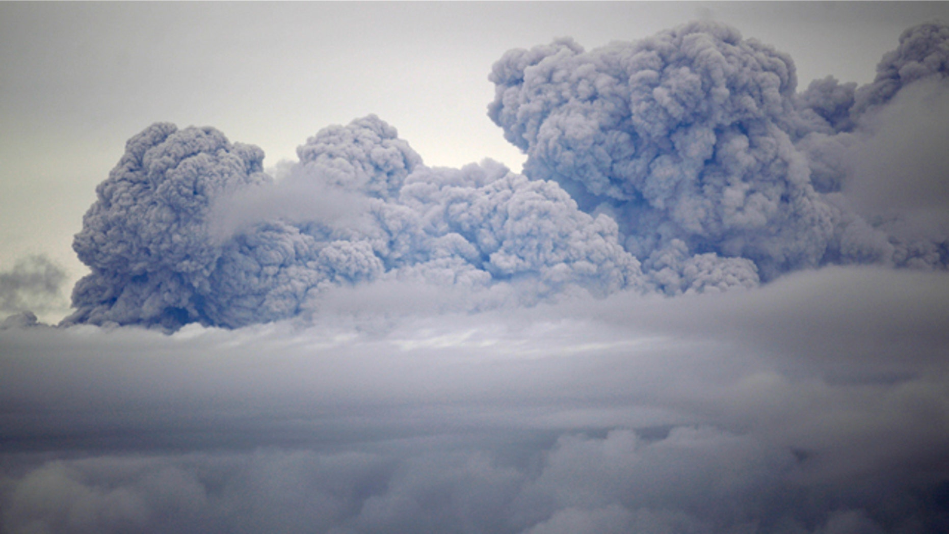 A cloud of volcanic ashes and smoke from the Puyehue-Cordon Caulle volcano is seen from Entrelagos, in southern Chile, Friday, June 10, 2011. The volcano erupted Saturday after remaining dormant for decades, causing the evacuation of about 3,500 people in the nearby area and carrying ash across the Andes to Argentina. (AP Photo/Roberto Candia)