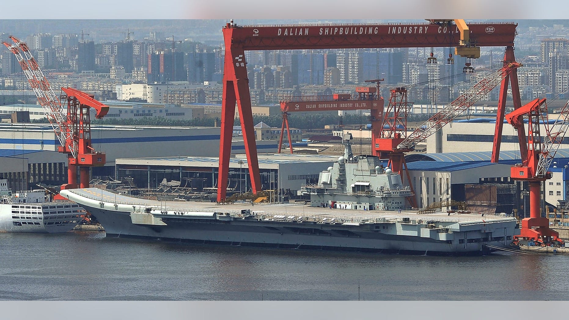 Aug. 6: In this photo, a Chinese aircraft carrier, which had been under refurbishment, is docked at Dalian port in in northeast Liaoning province. China's first aircraft carrier started sea trials Wednesday, Aug. 10, a step that will likely boost concerns about the country's naval ambitions amid sea territorial disputes.