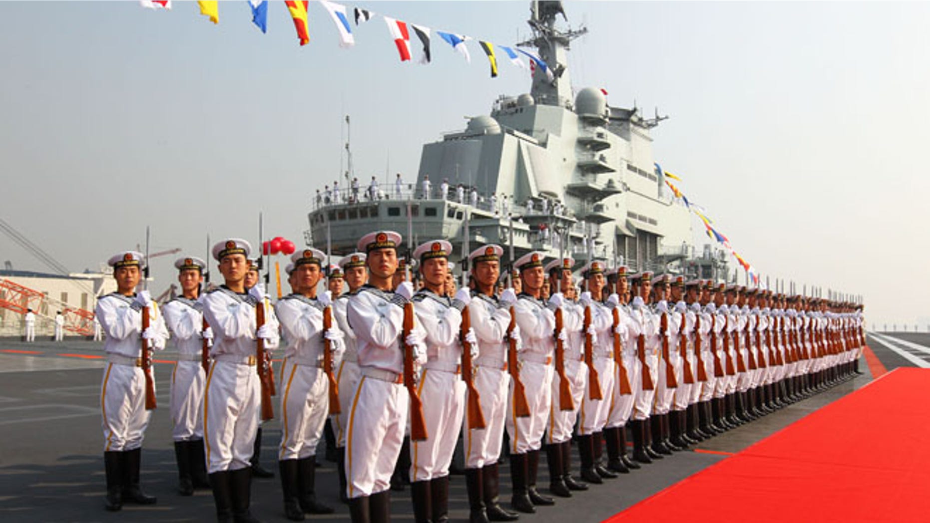 Sept. 25, 2012: Military officers stand onboard China's aircraft carrier "Liaoning" in Dalian, northeast China's Liaoning Province, as the country formally entered its first aircraft carrier into service.