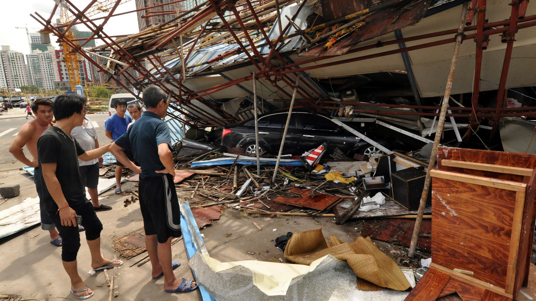 July 19, 2014 - Vehicle sits under a collapsed building after landfall of typhoon Rammasun in Haikou, capital of south China's Hainan Province. The strongest typhoon to hit southern China in four decades has killed at least 26 people in China, and 11 more in Vietnam.