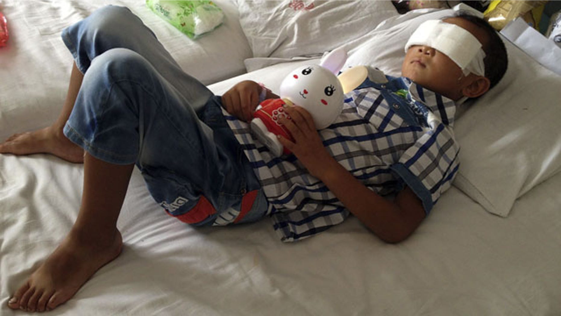 August 28, 2013: Guo Bin lies on a bed in a hospital as he recuperates from an attack in the rural area of Linfen city that left him blind, in Taiyuan in northwest China's Shanxi province. (AP Photo)
