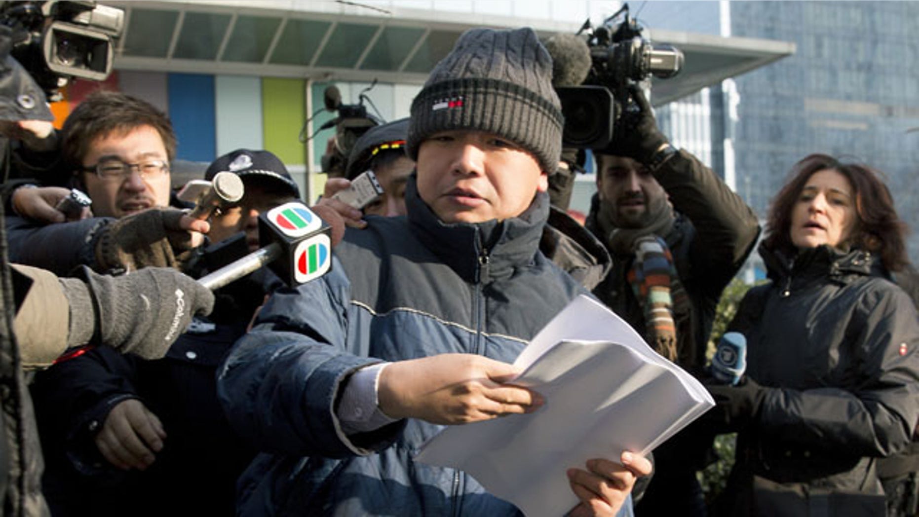 January 26, 2014: Zhang Qingfang, lawyer of legal scholar and founder of the New Citizens movement Xu Zhiyong, speaks to the media near the No. 1 Intermediate People's Court, in Beijing . The Beijing court on Sunday sentenced Xu to four years in jail for disrupting order in public places, in a case that the U.S. government and other critics say is retribution against his push to fight corruption and create equal educational opportunities. (AP Photo/Andy Wong)