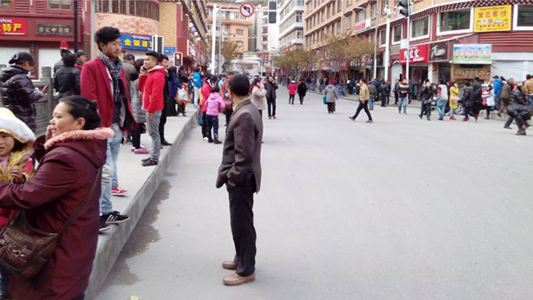Nov. 22, 2014: In this photo released by China's Xinhua News Agency, locals stand outside after a quake hit Kangding County in Sichuan Province, China. (AP)