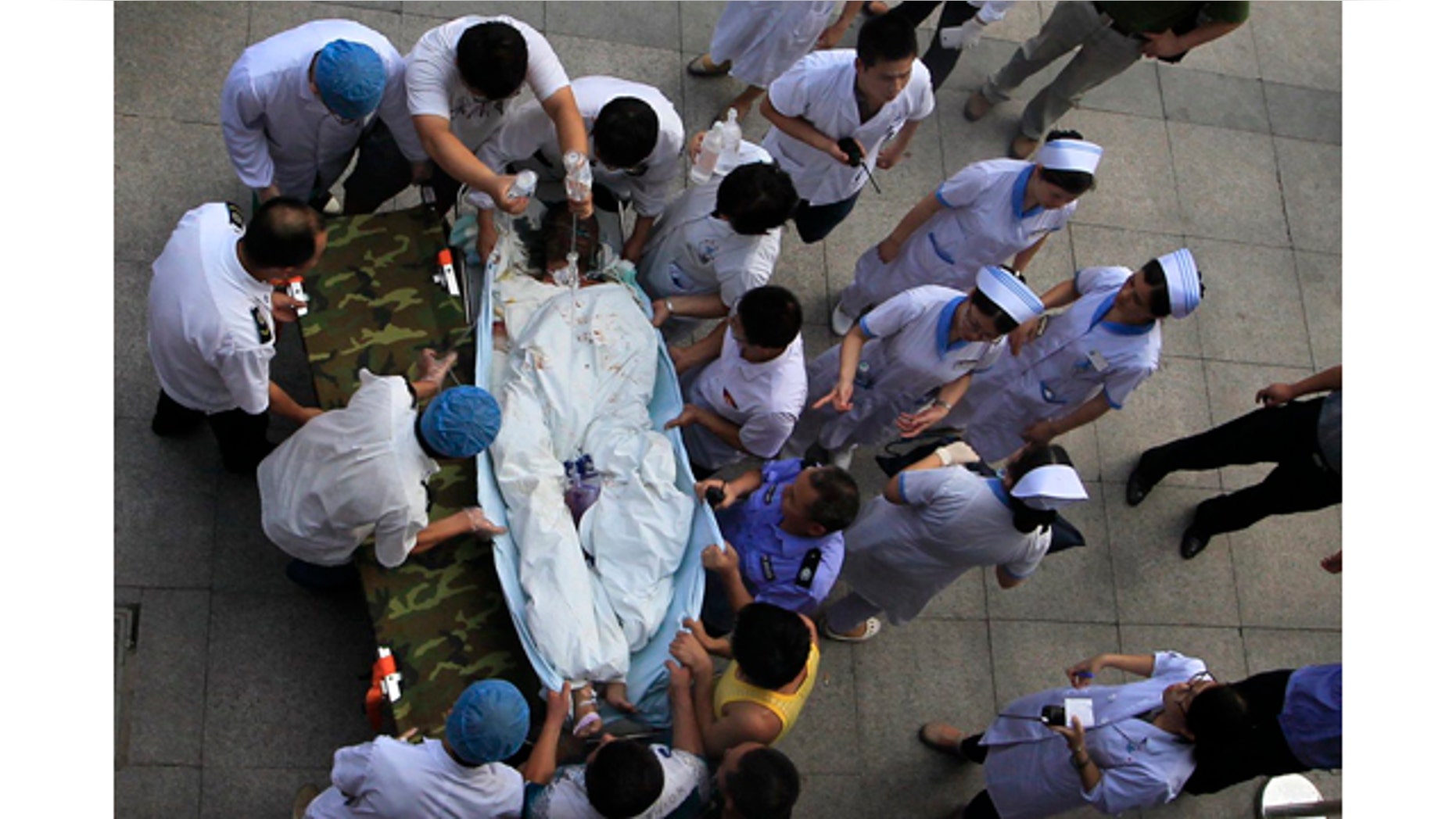 August 2, 2014: Medical staff move a severely burnt victim of an explosion at an eastern Chinese automotive parts factory from a hospital in the city of Kunshan, Jiangsu province to a Shanghai hospital which is better equipped to handle severe burns. Dozens of people were killed Saturday by the explosion at the factory that supplies General Motors, state media reported. (AP Photo)