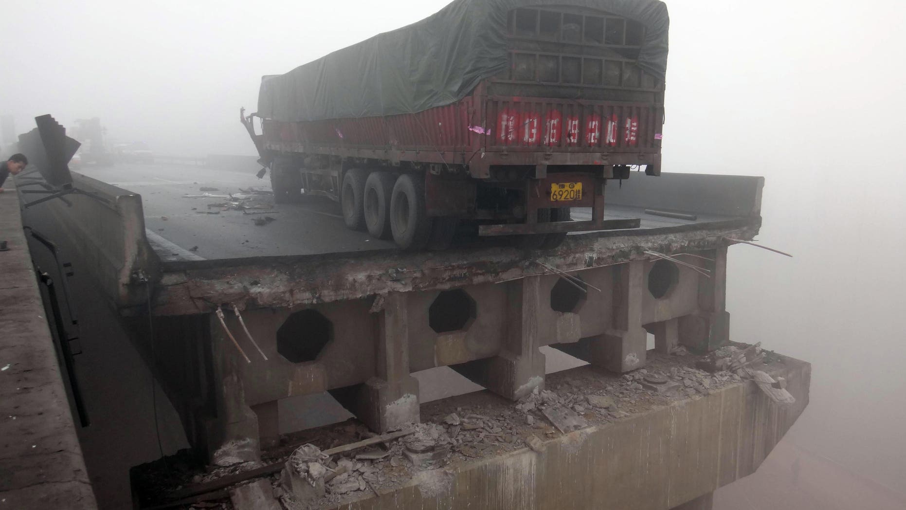 Feb. 1, 2013: In this photo provided by China's Xinhua News Agency, a truck sits on the expressway bridge which partially collapsed due to an explosion in Mianchi County, Sanmenxia, central China';s Henan Province.