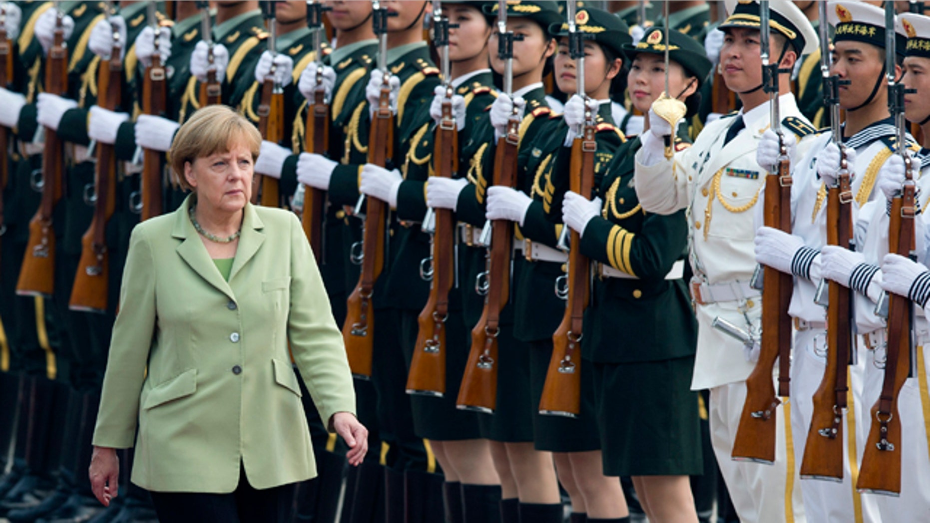 July 7, 2014: German Chancellor Angela Merkel reviews an honor guard during a welcome ceremony outside the Great Hall of the People in Beijing, China.(AP Photo/Andy Wong)