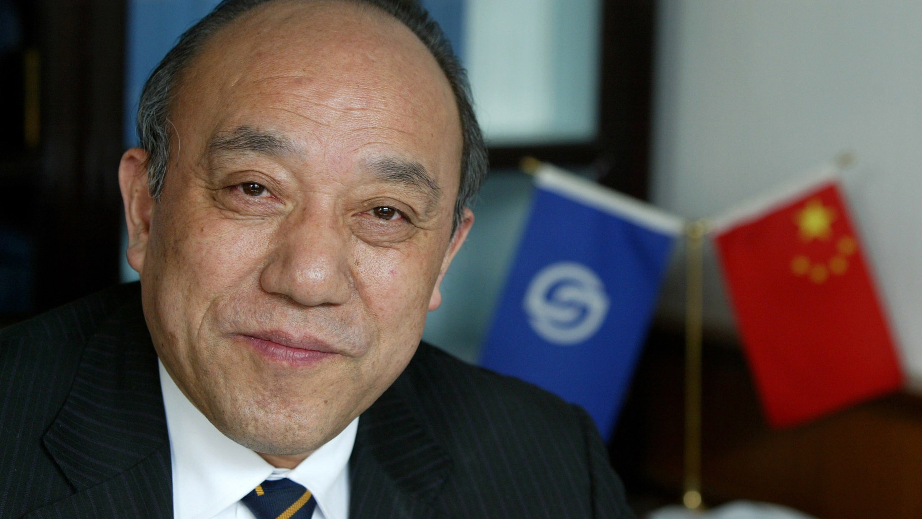 Feb. 21, 2004: Lu Guanqiu, board chairman of Wanxiang Group, sits in his office at the company's headquarters in Xiaoshan, China.