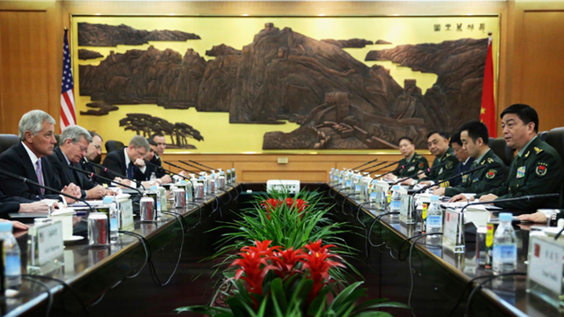 April 8, 2014: U.S. Secretary of Defense Chuck Hagel, left, and Chinese Minister of Defense Chang Wanquan, right, take seat prior to their meeting at the Chinese Defense Ministry headquarters in Beijing. Hagel arrived in Beijing after a stop in Japan, where he told reporters that China must be more open about its military buildup and better respect its neighbors - a pointed allusion to Beijing's ongoing territorial dispute with Japan and others over remote islands in the East China Sea. (AP Photo/Alex Wong, Pool)