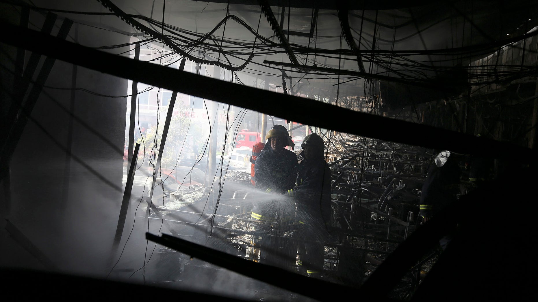 April 14, 2013: Firefighters extinguish a fire at a hotel in Xiangyang city in central China's Hubei province. A fire at an Internet cafe spread to a hotel in central China on Sunday, killing 11 people and injuring 50 others, state media and firefighters said.