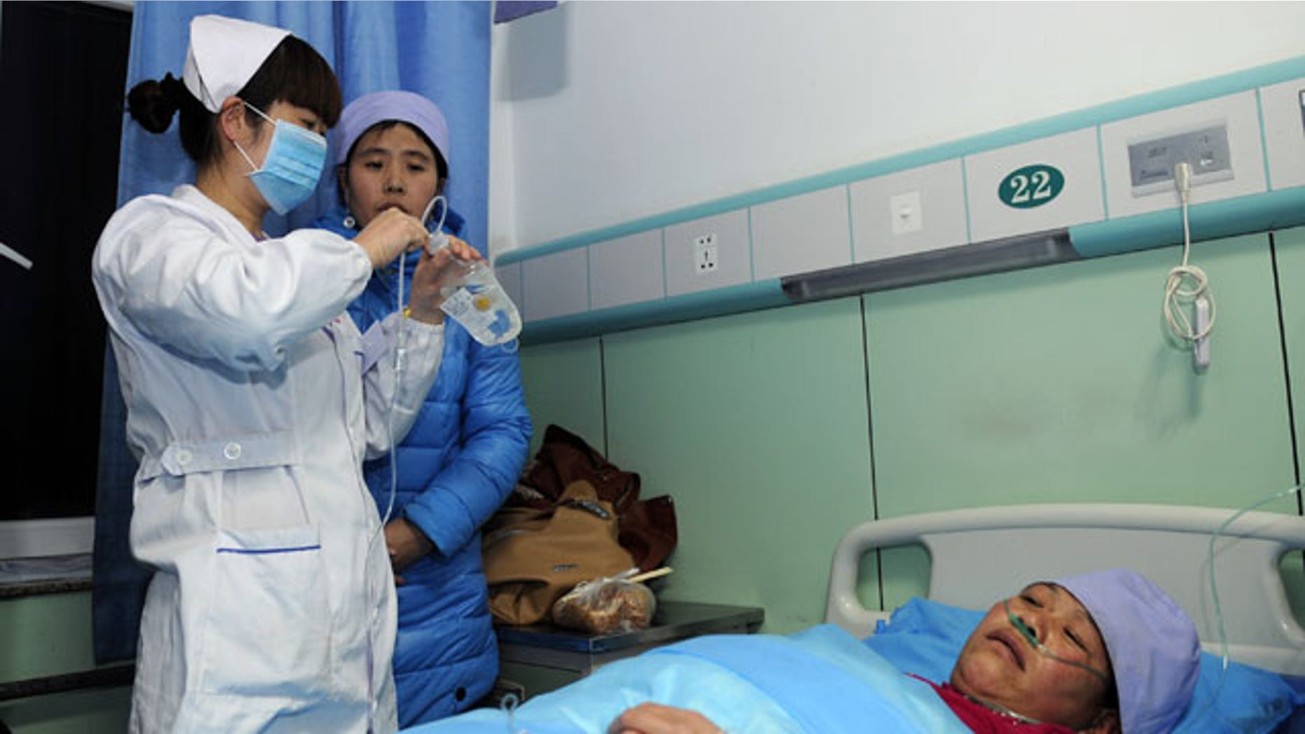 January 5, 2014: An injured woman receives medical treatment at a hospital in Xiji Town of Guyuan, northwest China's Ningxia region. China's Xinhua News Agency said Monday that 14 people were killed in a stampede at a mosque in the country’s north and 10 other people were injured in the incident in Guyuan. (AP Photo/Xinhua, Li Ran)