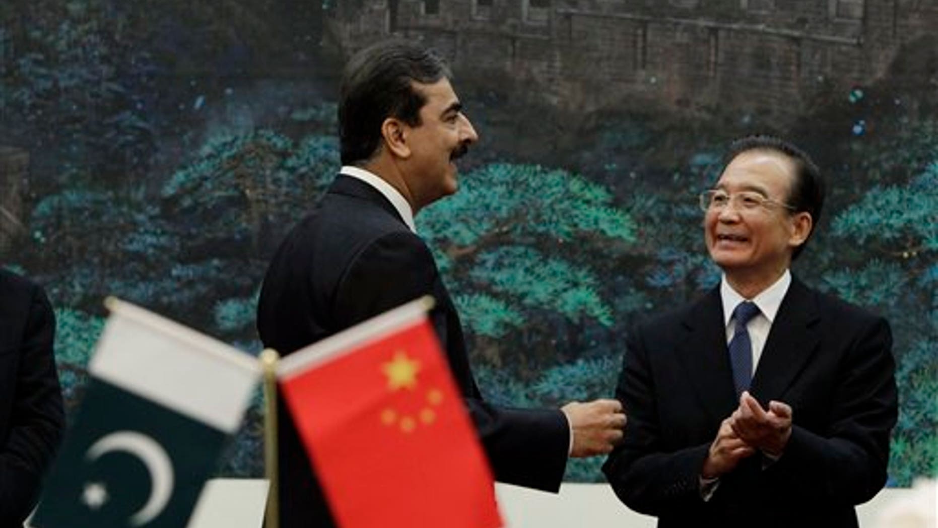 May 18: Pakistan's Prime Minister Yousuf Raza Gilani speaks to China's Premier Wen Jiabao after a singing ceremony at the Great Hall of the People in Beijing.