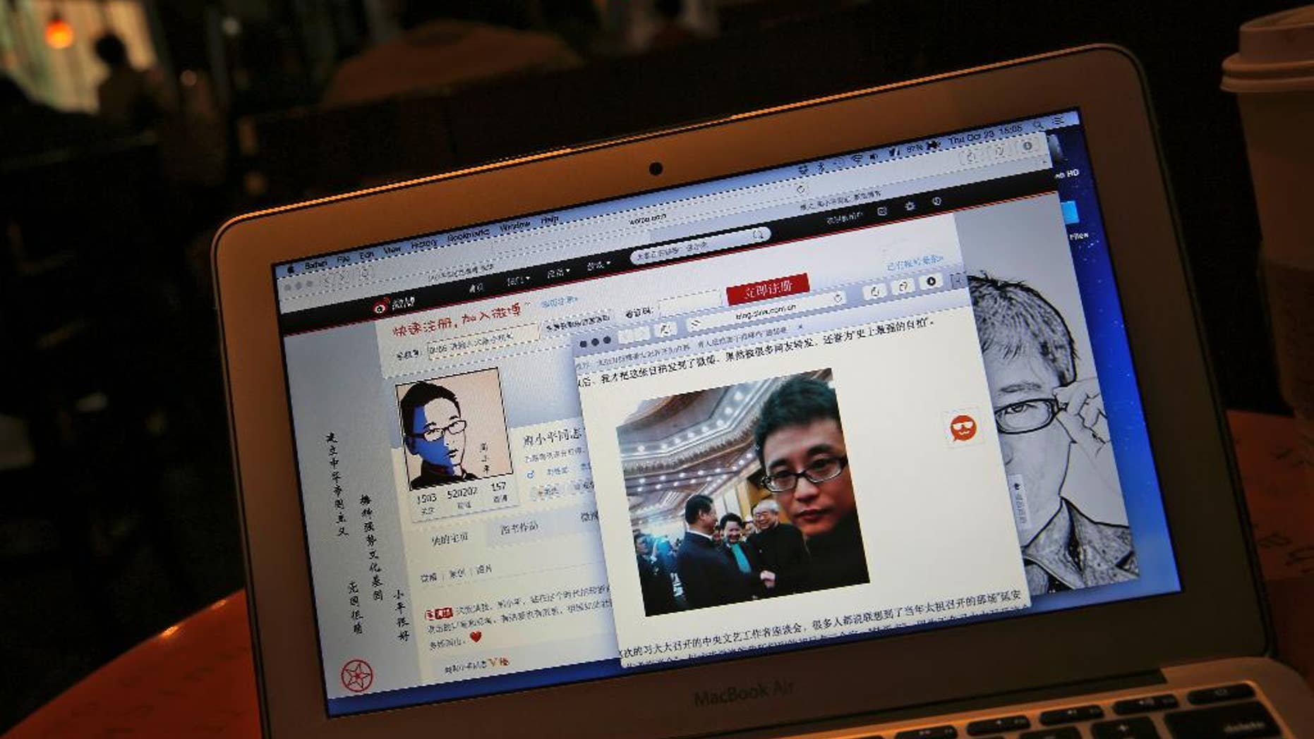 This screen shot shows Chinese Patriotic Blogger, Zhou Xiaoping's Sina Weibo account and his selfie near Chinese President Xi Jinping with officials at the Great Hall of the People, in his blog, in Beijing, China Thursday, Oct. 23, 2014. He shook hands with President Xi Jinping earlier this month in a rare literature and arts meeting, where the 33-year-old blogger sat along with Chinese novelist and Nobel literature laureate Mo Yan. Zhou said in his blog that Xi told him to keep spreading “positive energy on the Internet.” (AP Photo/Andy Wong)