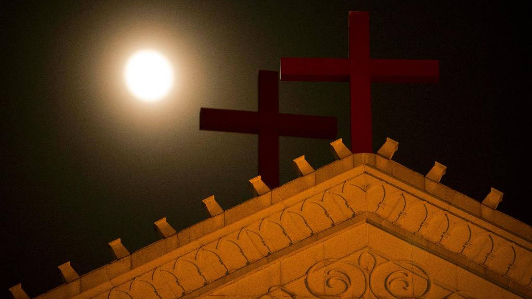 In eastern China's Zhejiang Province church members are keeping a 24-hour vigil to watch for Chinese government workers coming to remove the building's crosses.