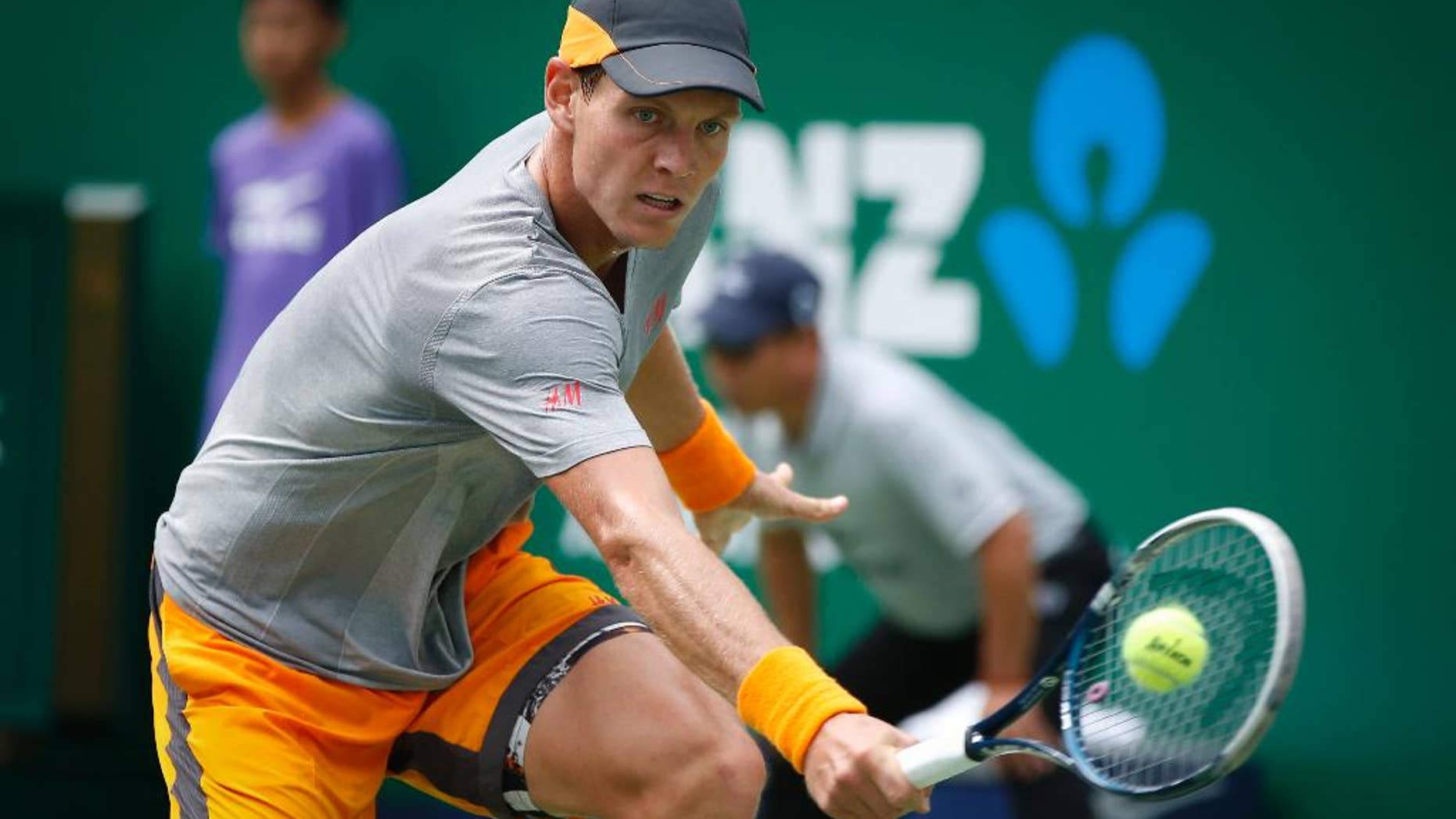 Tomas Berdych of the Czech Republic returns a shot against Gilles Simon of France during their men's singles quarterfinal match at the Shanghai Masters tennis tournament in Shanghai, China, Friday, Oct. 10, 2014. (AP Photo/Vincent Thian)