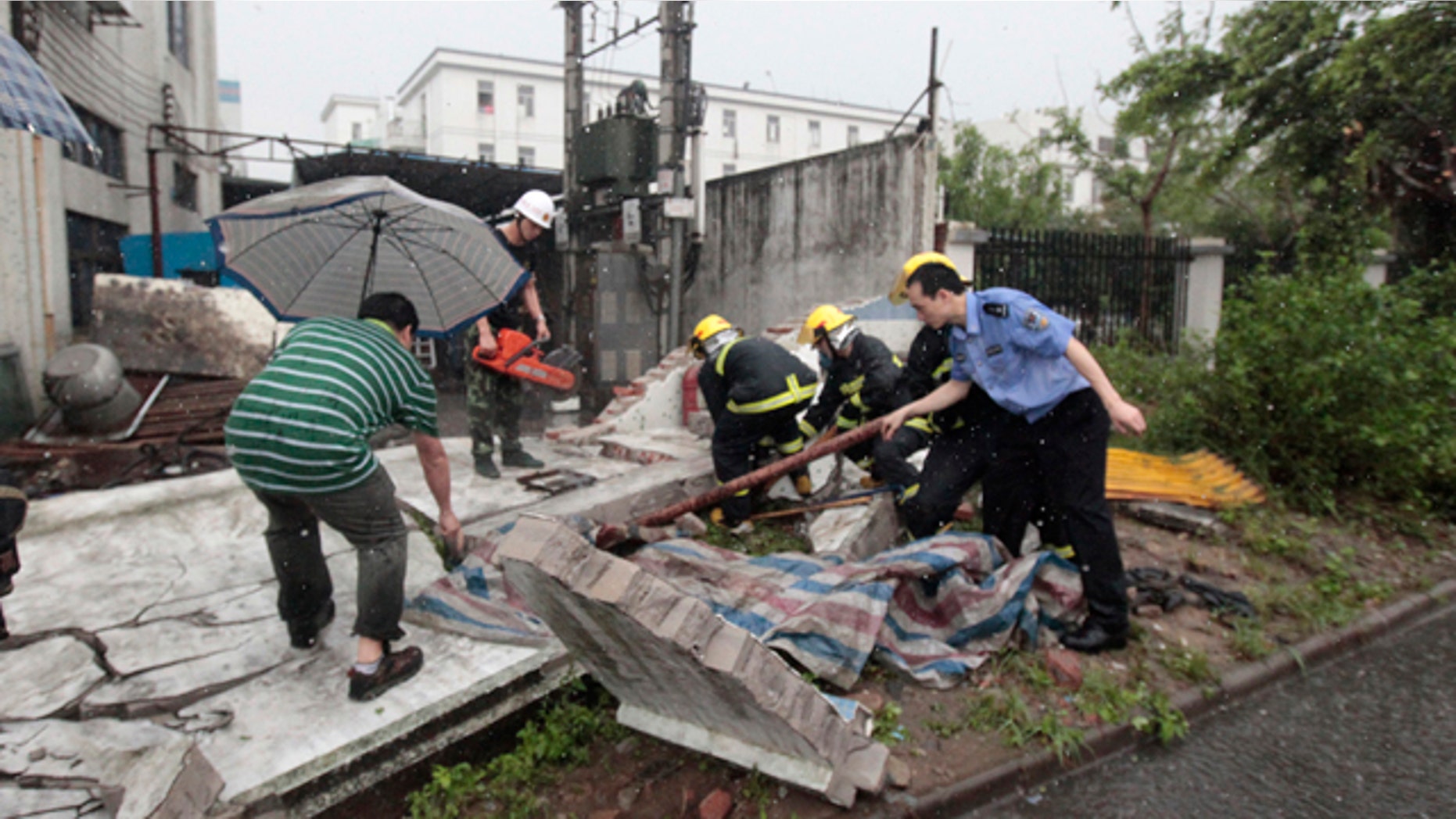April 17: In this photo released by China's Xinhua News Agency, rescue team tries to save a resident trapped under a house which collapsed in a storm disaster in Foshan City, China's Guangdong Province.