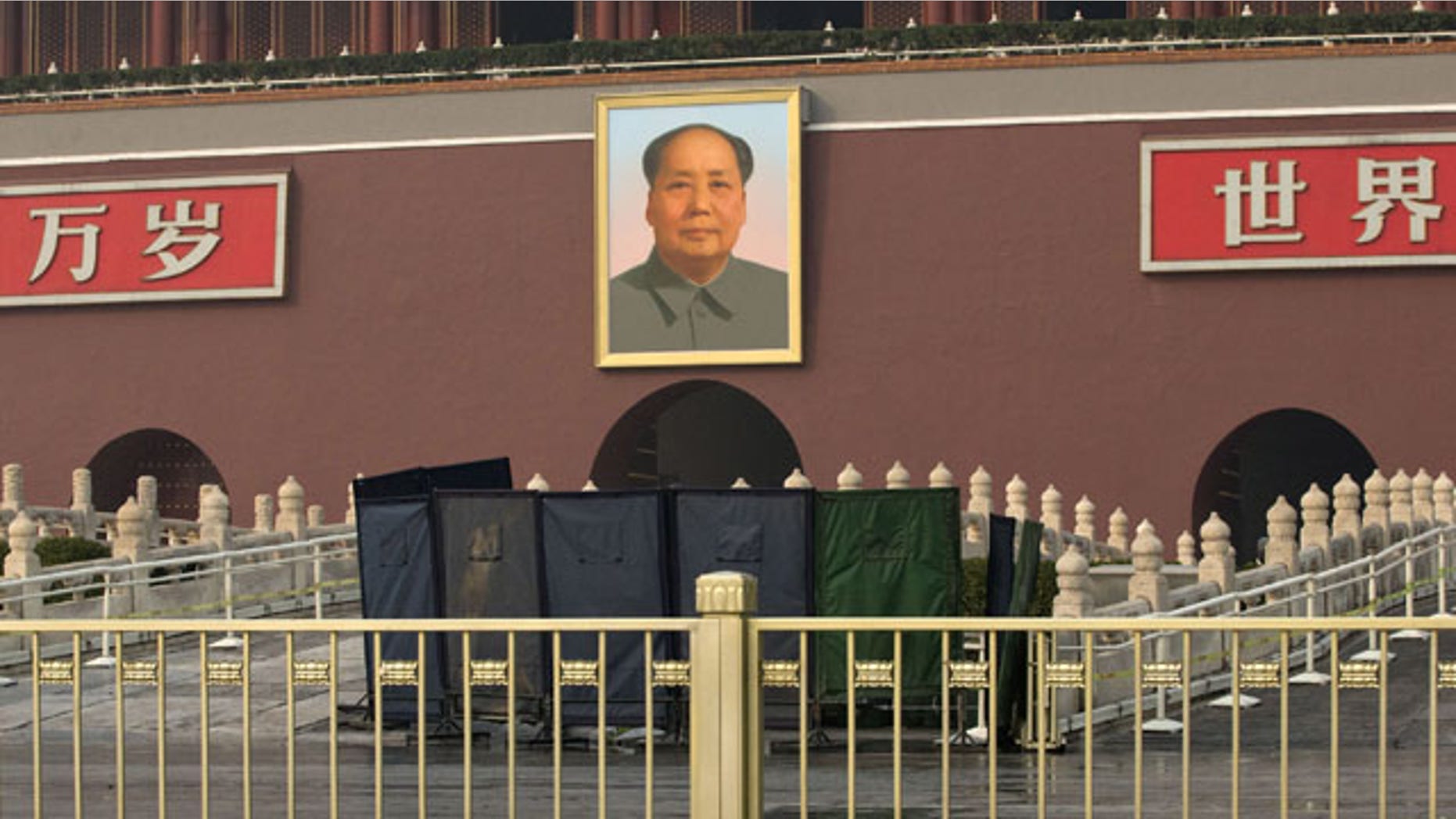 October 28, 2013: An area in front of Tiananmen Gate is shielded following a car fire in Beijing, China, Monday, Oct. 28, 2013. A sport-utility vehicle veered into a crowd in front of Beijing’s Forbidden City and then crashed and caught fire Monday, killing three people and injuring several, police said. (AP Photo/Alexander F. Yuan)