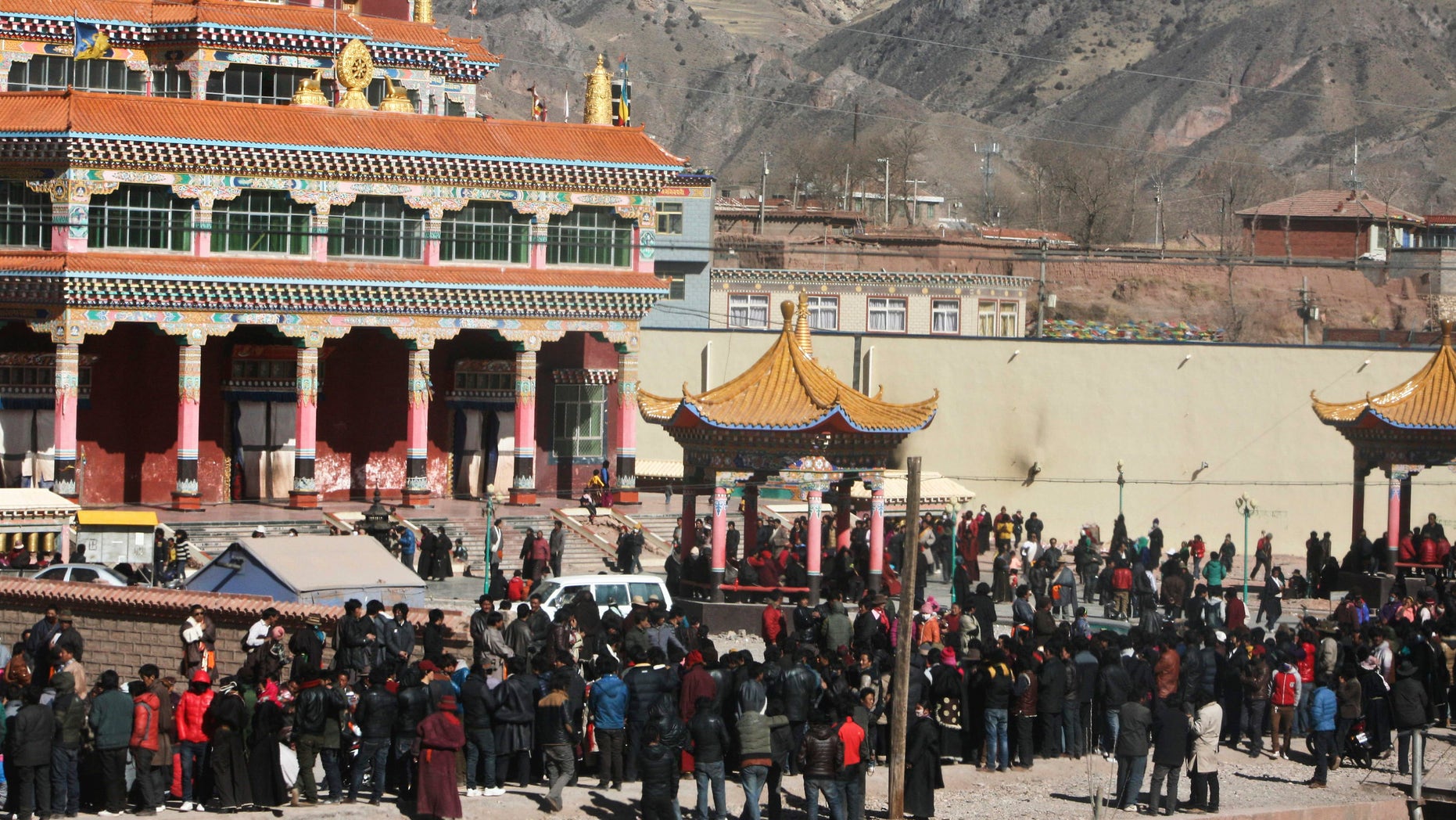 Feb. 8, 2012: Hundreds of Tibetans gather on the side of a main street in Nangqian county, China's Qinghai province.