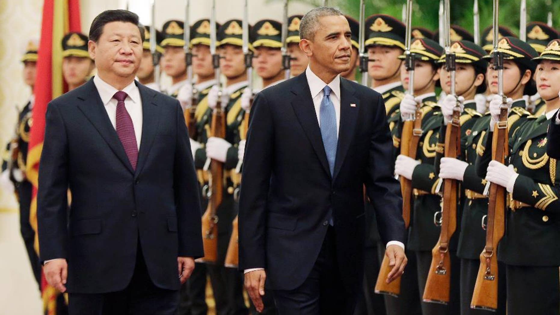 U.S. President Barack Obama, right, and Chinese President Xi Jinping review the honor guard during a welcome ceremony at the Great Hall of the People in Beijing, Wednesday, Nov. 12, 2014. When Xi Jinping took the reins of a booming China two years ago, President Barack Obama saw an opportunity to remake America's relationship with the Asian power. But even after Obama's unusually robust efforts to forge personal ties with Xi, the two leaders are meeting in Beijing amid significant tensions, both old and new. (AP Photo/Andy Wong)