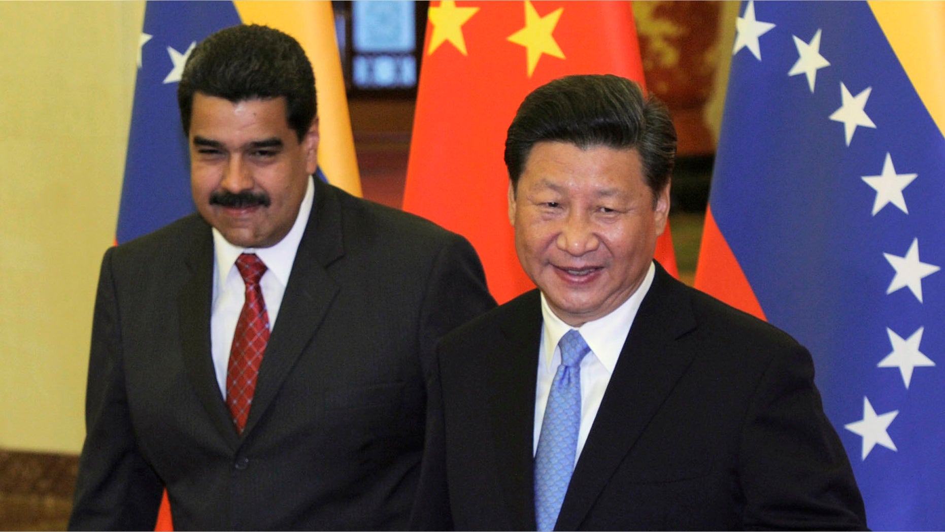 Chinese President Xi Jinping, right, walks with Venezuela's President Nicolas Maduro before their meeting at the Great Hall of the People in Beijing, China, Tuesday, Sept. 1, 2015. (Parker Song/Pool Photo via AP)