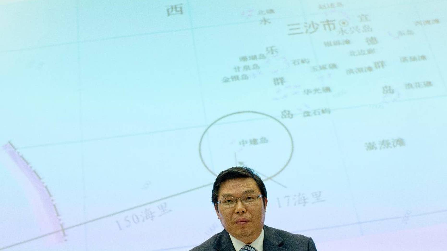 May 8, 2014: Yi Xianliang, deputy director-general of Chinese Ministry of Foreign Affairs' Department of Boundary and Ocean Affairs, stands up, in front of a map showing a disputed zone in South China Sea, to leave a press conference in Beijing, China.