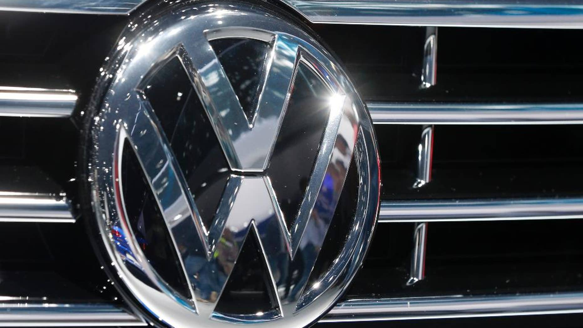 FILE - In this Sept. 22, 2015, file photo, the logo of Volkswagen at a car is photographed during the Car Show in Frankfurt, Germany. Volkswagen is recalling 1,950 diesel vehicles in China to correct engine software that the automaker has admitted cheats on emissions tests. The recall applies to 1,946 Tiguan sport utility vehicles and four Passat B6 sedans, all of them imported, the company said Monday, Oct. 12, 2015. It said technical solutions are being developed and have yet to be submitted to Chinese authorities for approval. (AP Photo/Michael Probst, File)