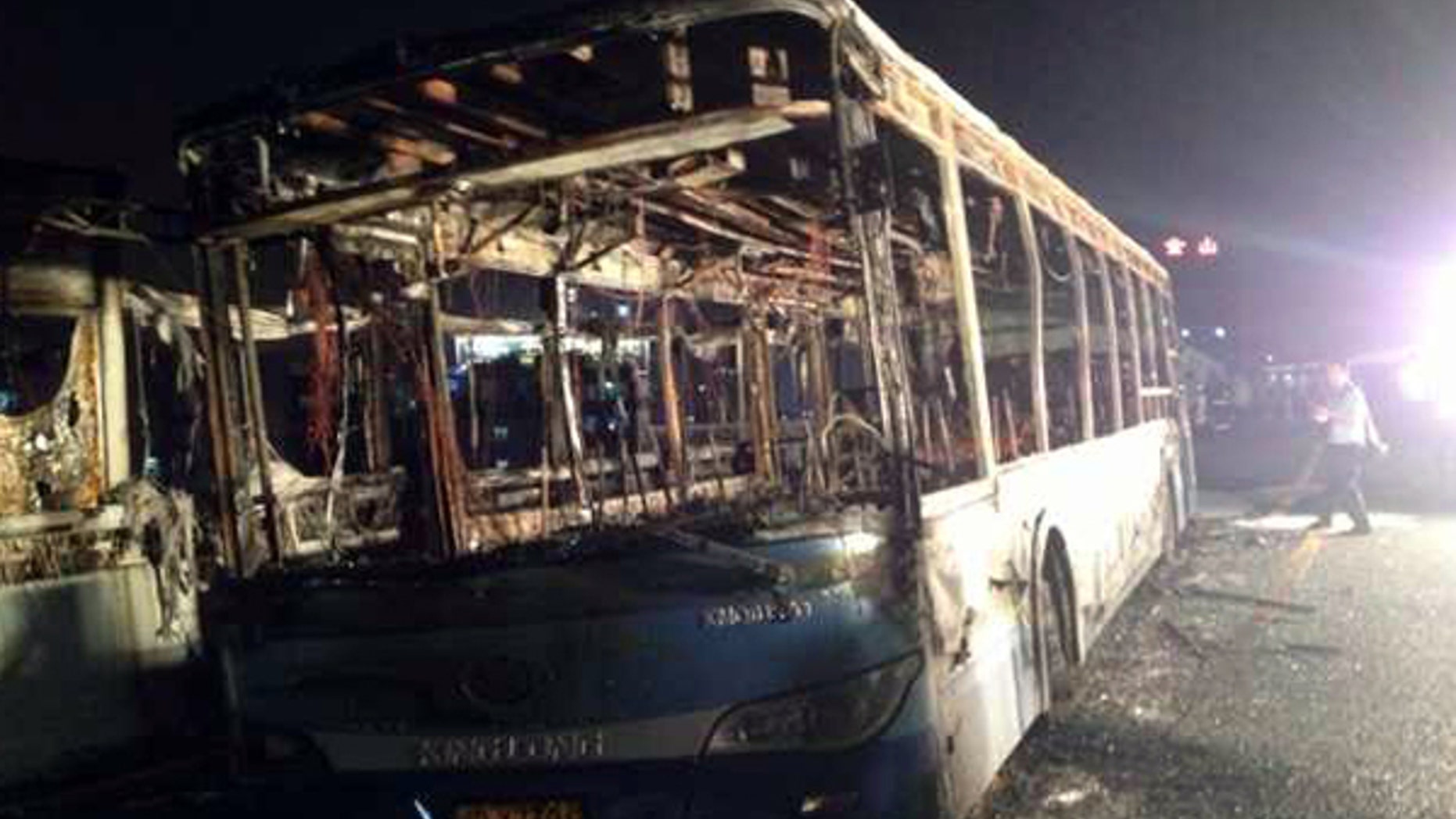 June 7, 2013: This image made with a mobile phone camera released by China's Xinhua News Agency shows the remains of an express bus that burst into flames in Xiamen, southeast China's Fujian Province. The express bus burst into flames on an elevated road in southeastern China on Friday, killing at least 30 people and injuring more than 30, state media reported.