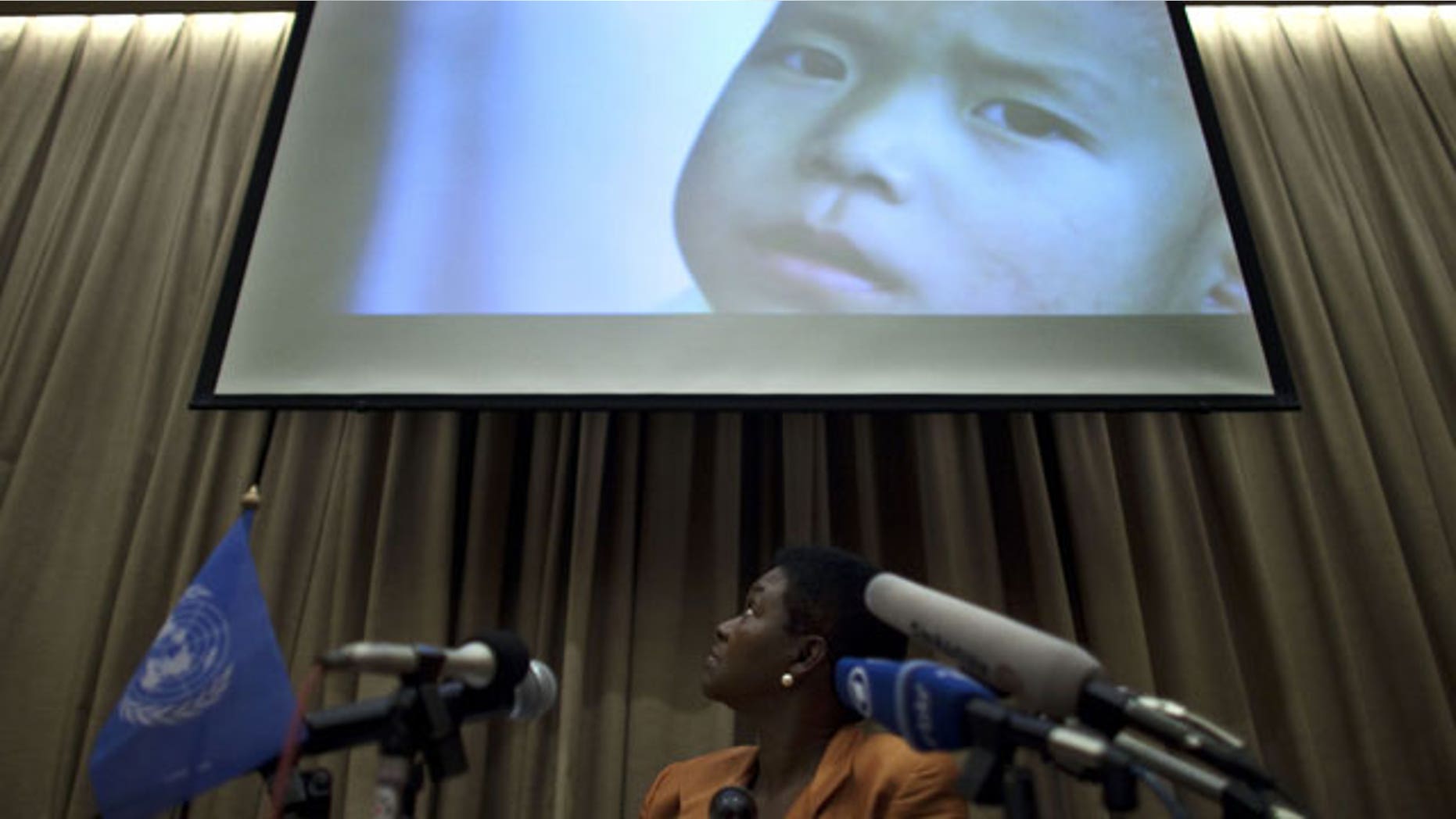 Oct. 21, 2011: Valerie Amos, U.N. undersecretary-general for Humanitarian Affairs and Emergency Relief Coordinator, looks at an image showing a North Korean child during a press conference in Beijing, China.