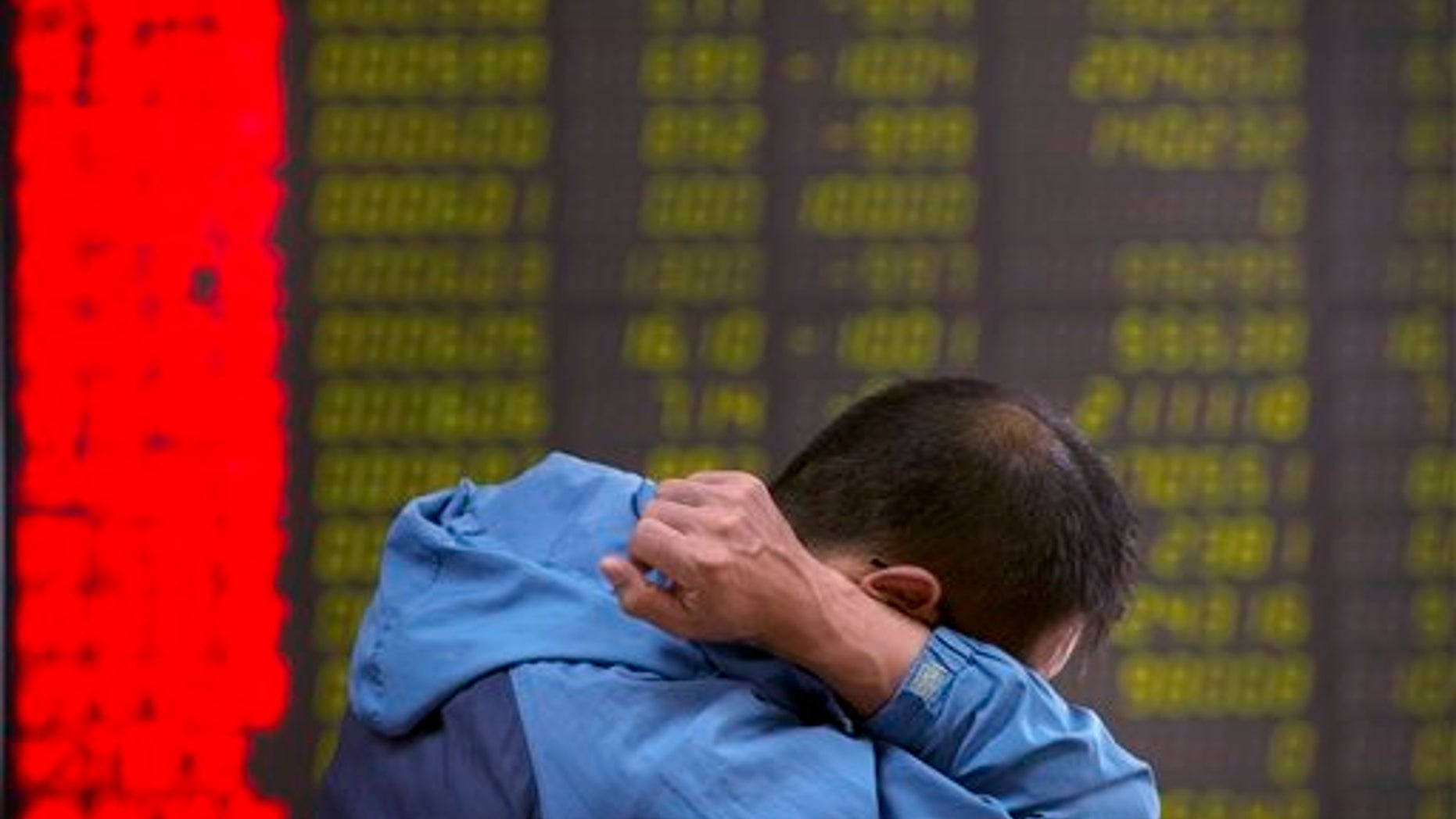 A Chinese investor monitors stock prices at a brokerage house in Beijing, Tuesday, Aug. 25, 2015. China's main stock market index has fallen for a fourth day, plunging 7.6 percent to an eight-month low. (AP Photo/Mark Schiefelbein)