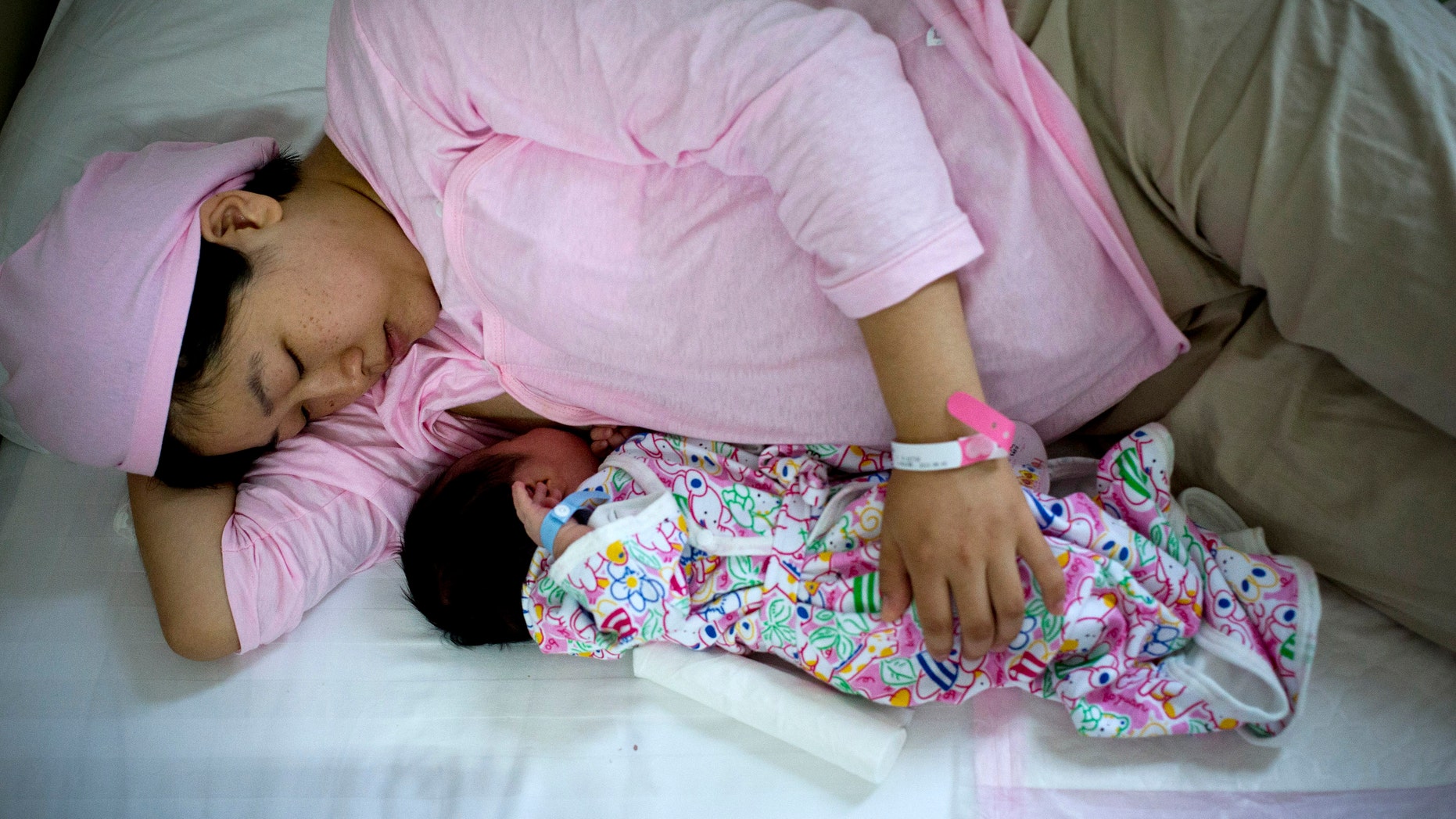 New mother Qi Wenjuan breastfeeds her 1-day-old son at Tiantan Hospital's maternity ward in Beijing, China. (AP Photo/Andy Wong)