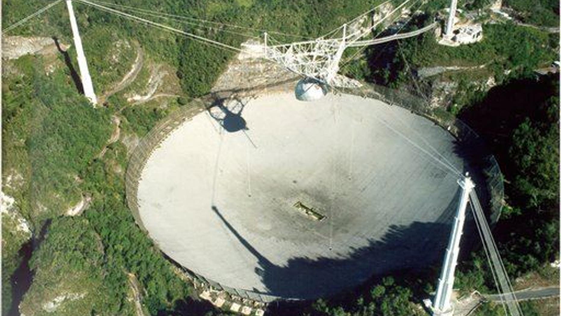 China's soon-to-be-completed FAST radio telescope will dwarf the Arecibo radio telescope in Puerto Rico, shown here. The Chinese government is forcing more than 9,000 people from their homes to make room for it.