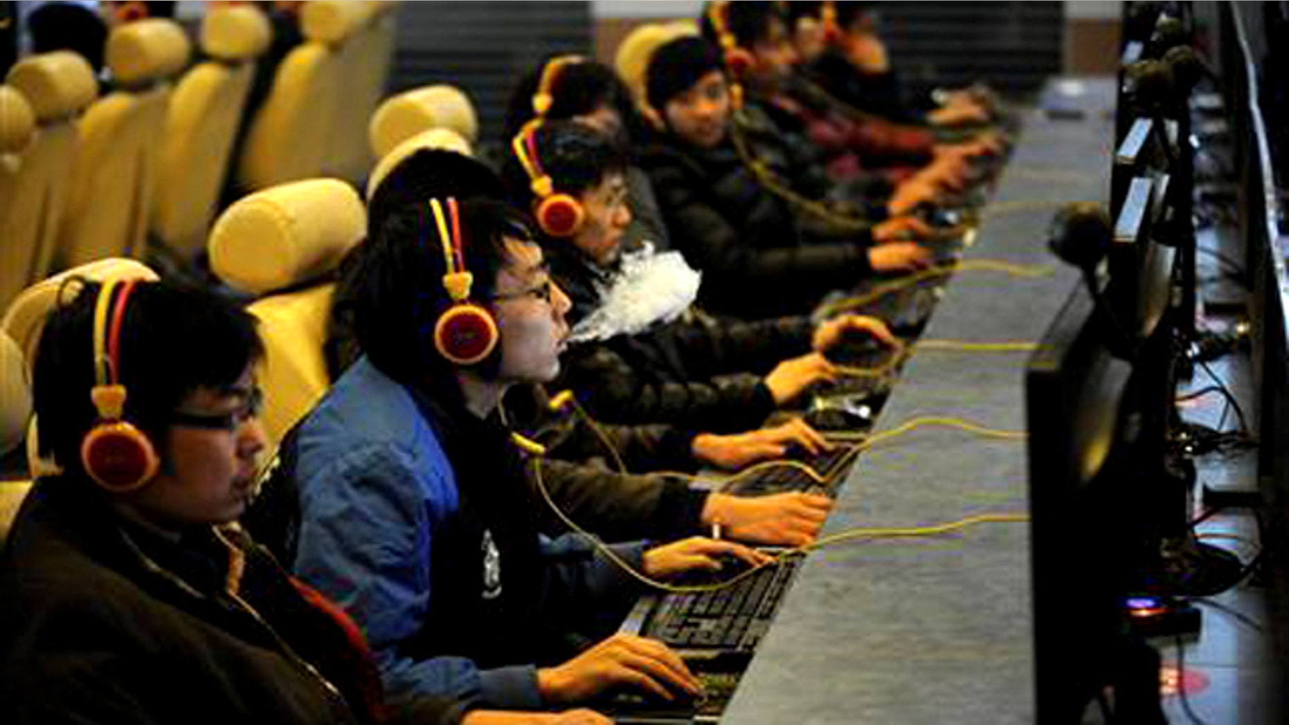 A man smokes while using a computer at an Internet cafe in Taiyuan, Shanxi province December 30, 2010. China shut down more than 60,000 pornographic websites this year, netting almost 5,000 suspects in the process, a government spokesman said on Thursday, vowing no let-up in its campaign against material deemed obscene.