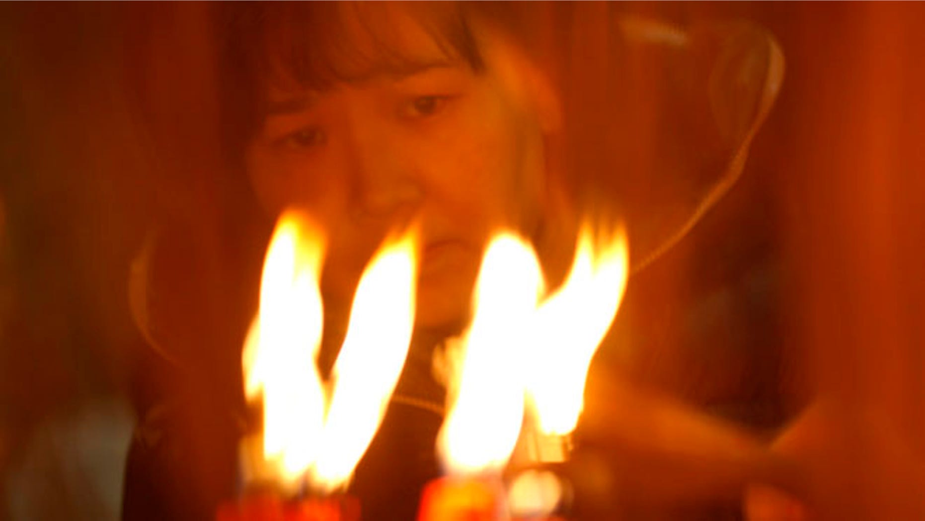 A worshipper burns joss sticks at a temple on the third day of the Chinese Lunar New Year celebrations Wednesday Jan. 25, 2012 in Hong Kong. (AP Photo/Vincent Yu)